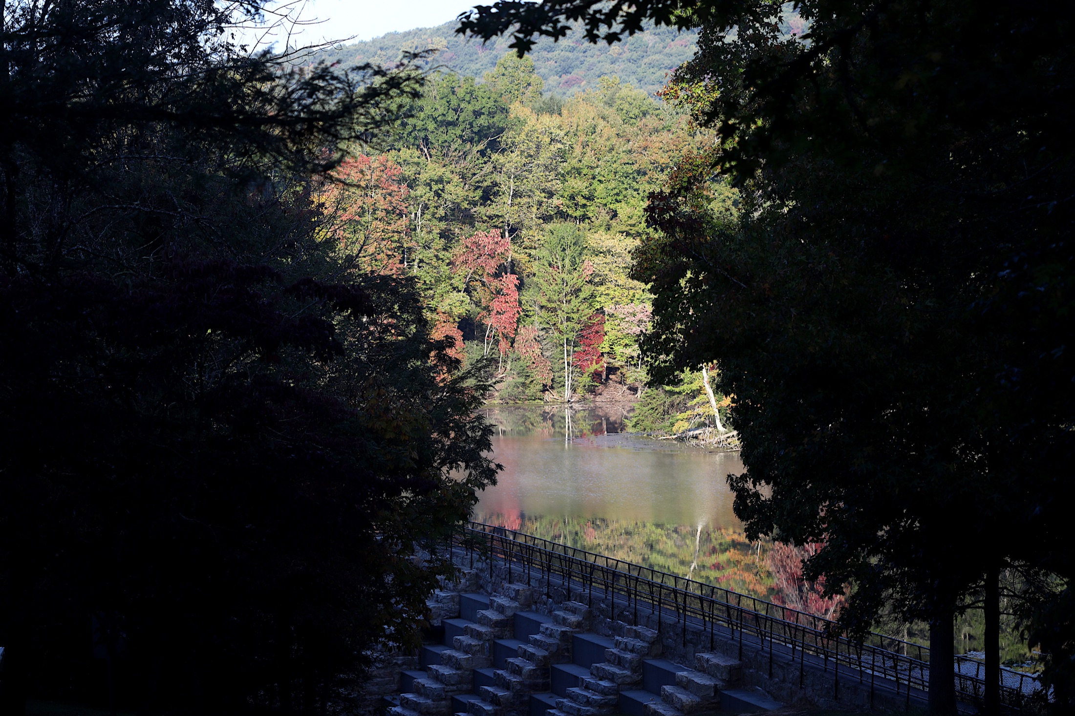 Bays Mountain Reservoir in Kingsport, Tennessee, surrounded by autumn trees reflected in the water
